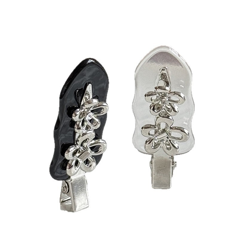 Black and clear acetate side hair clips with silver-colored flower details