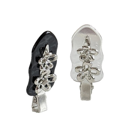 Black and clear acetate side hair clips with silver-colored flower details