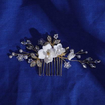 Floral hair comb displayed on deep blue fabric