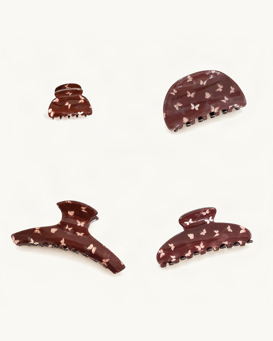 Butterfly Print Acrylic Claw Clip Set of 4 — Chocolate set of four claw clips on a warm ivory background [FITINY Hair]