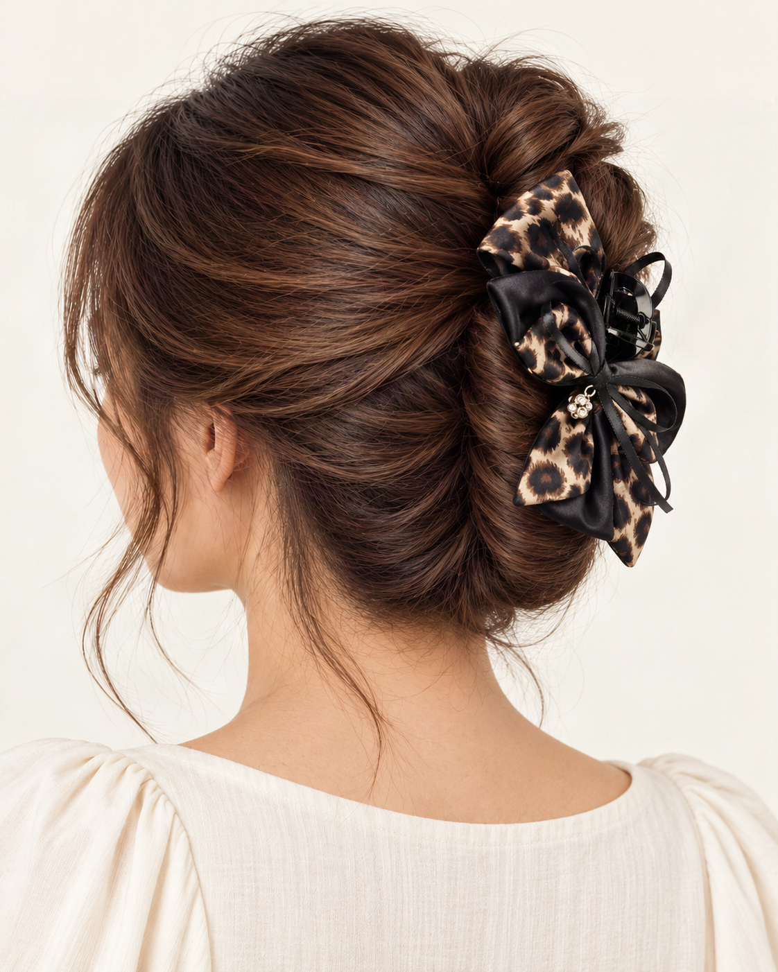 Satin Leopard Print Bow Hair Claw Clip — shown worn in natural hair to show placement and scale [FITINY Hair model]