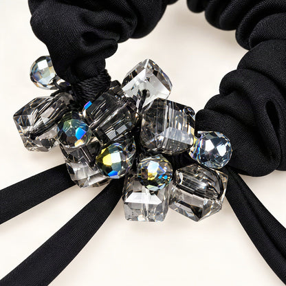 Close-up of faceted square and round crystals on a satin scrunchie [FITINY Hair]