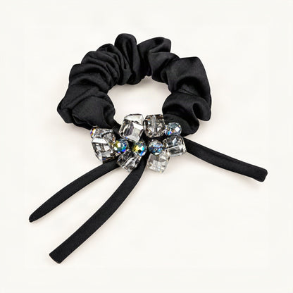 Front detail of clear square and iridescent round crystals on black satin scrunchie with ribbon tails [FITINY Hair]