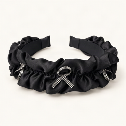 Rhinestone Bow Satin Padded Headband with Ruffled Trim — black ruffled satin headband, frontal angle [FITINY Hair]
