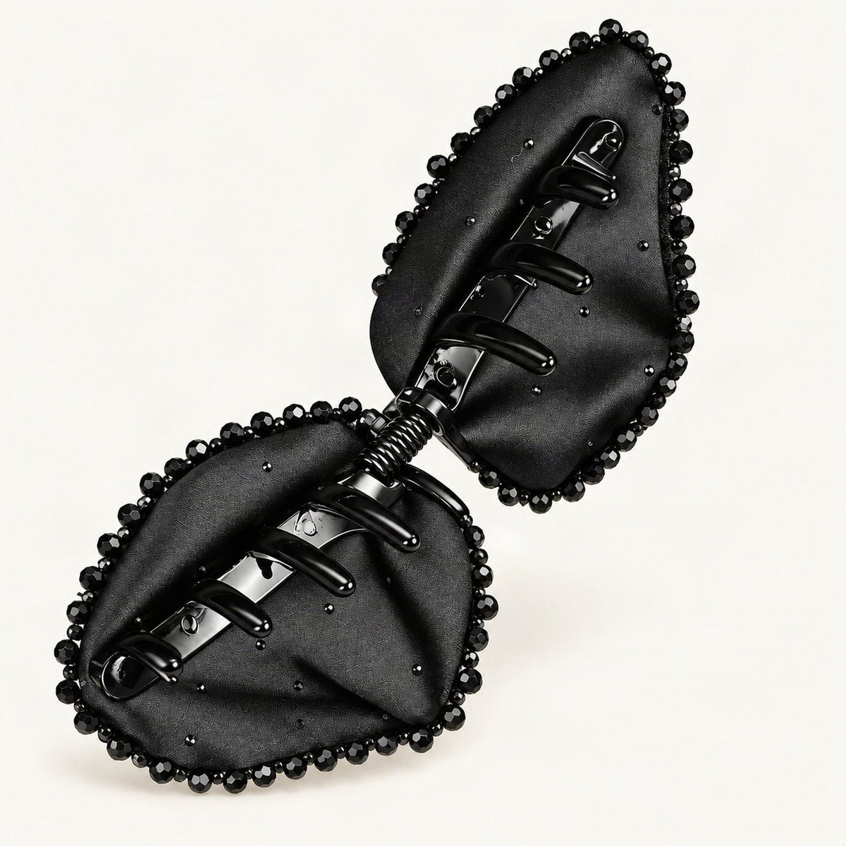 Black Satin Bow Claw Clip — open underside and spring mechanism on a warm ivory background [FITINY Hair]