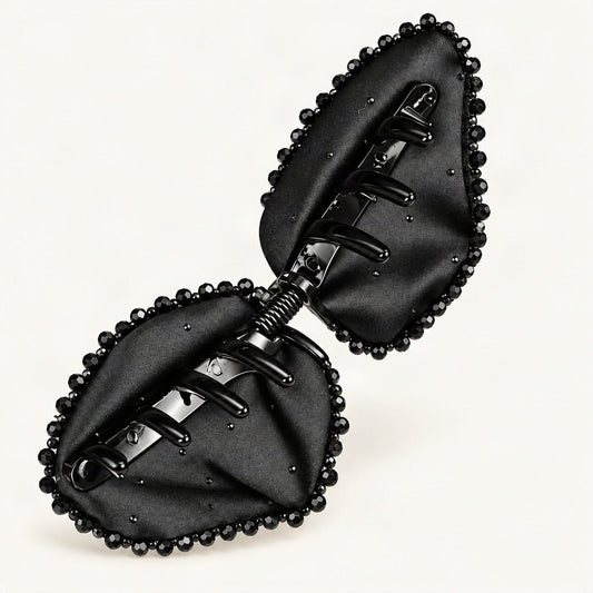 Black Satin Bow Claw Clip — open underside and spring mechanism on a warm ivory background [FITINY Hair]